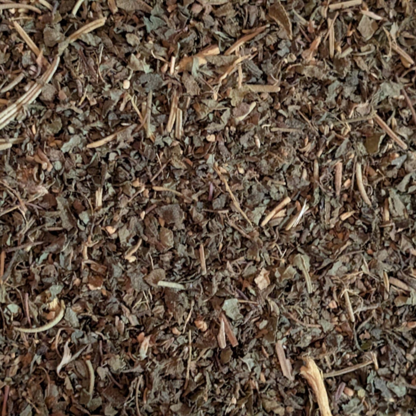 Close-up of dried herbs and leaves with a brown and green color palette.