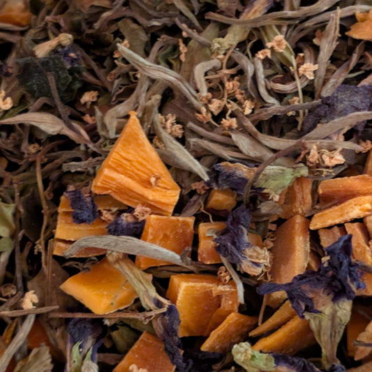 Close-up of dried herbs and flowers with orange and purple tones