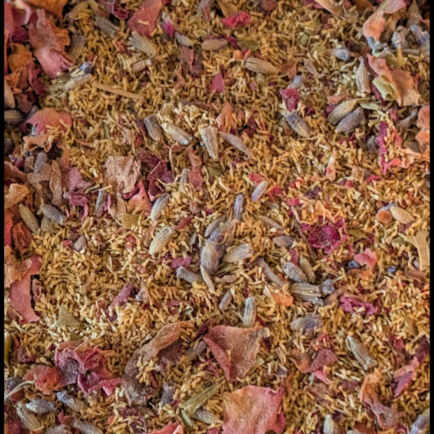 Close-up of a mix of dried herbs and flowers with a focus on texture and color.